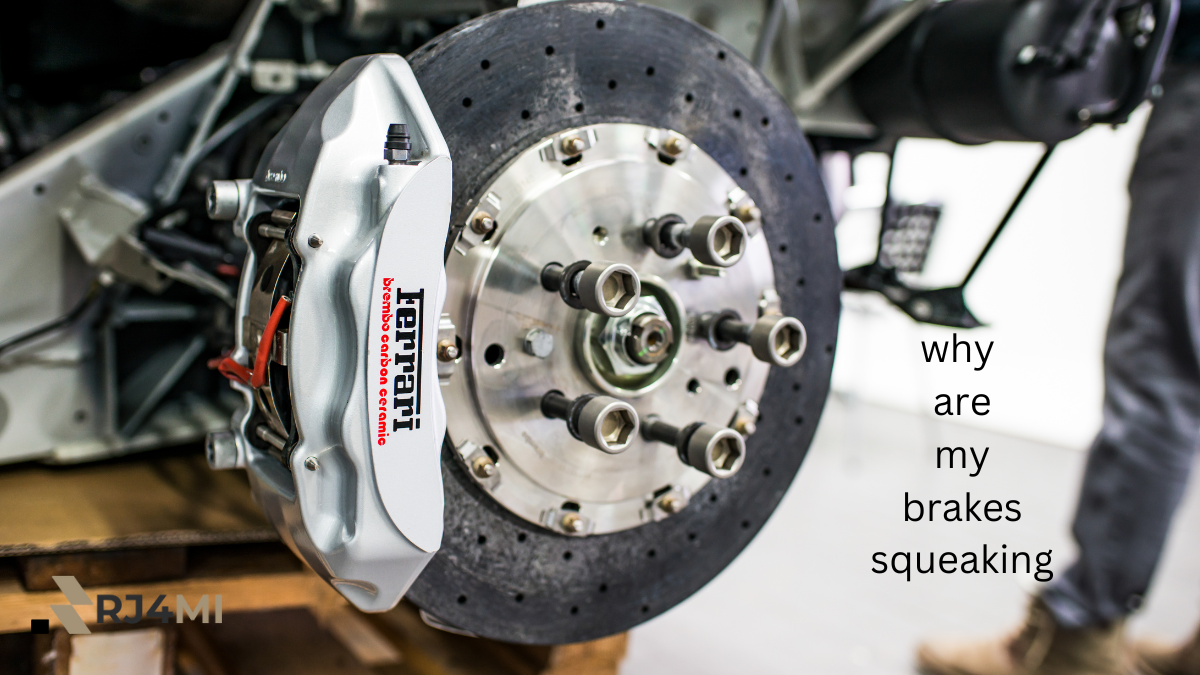 Close-up of a high-performance Ferrari brake system with a Brembo carbon ceramic brake caliper, featuring the text 'why are my brakes squeaking' written on the side. The image highlights the brake caliper, rotor, and bolts on a workshop setting.