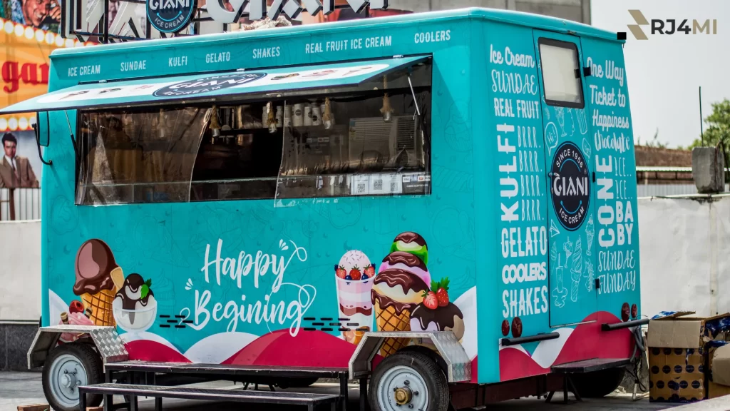 A colorful ice cream food truck with various treats, perfect for events and parties.