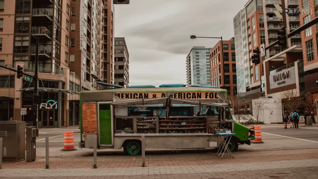 A vibrant food truck serving Mexican and American food in a city street setting, ideal for events.