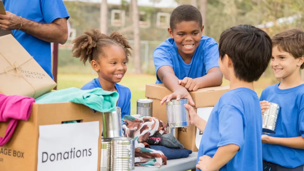 What does charity and sincerity mean? Children volunteering to collect donations, showcasing sincerity in helping those in need.
