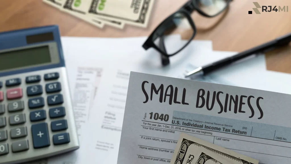 A tax document labeled "Small Business" with money, a calculator, and glasses, symbolizing financial management.