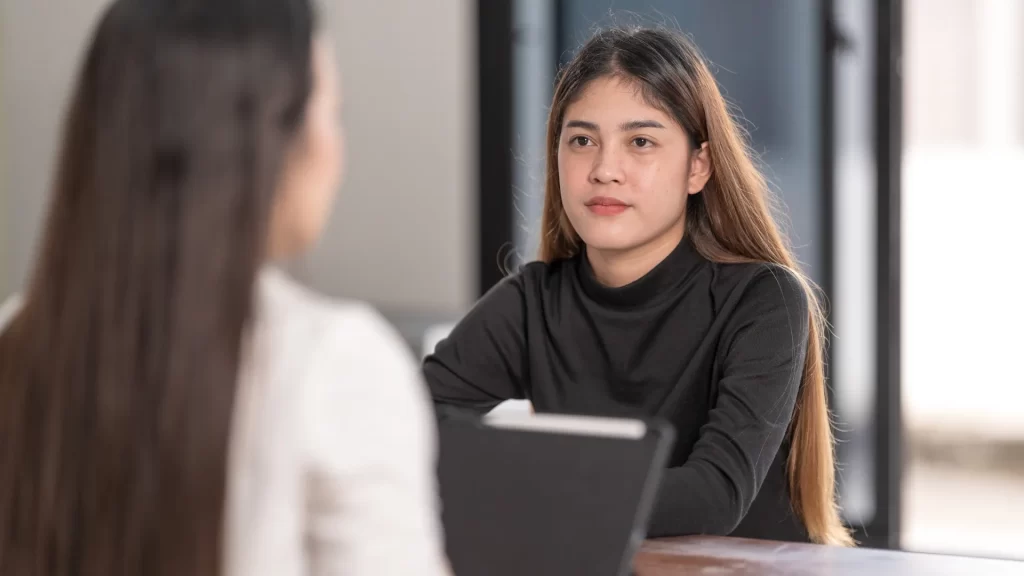 A young woman in a consultation session, representing an educational consultant's interaction with clients.