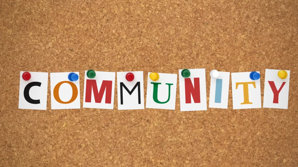 Colorful letters spelling "COMMUNITY" on a corkboard, suggesting that activities fostering unity can count as community service